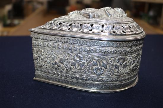 A Burmese silver teardrop shaped box with pierced cover containing minor items of jewellery.
